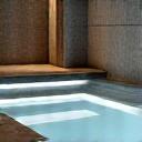 Luxurious in-home spa with a therapeutic pool and elegant stone finishes